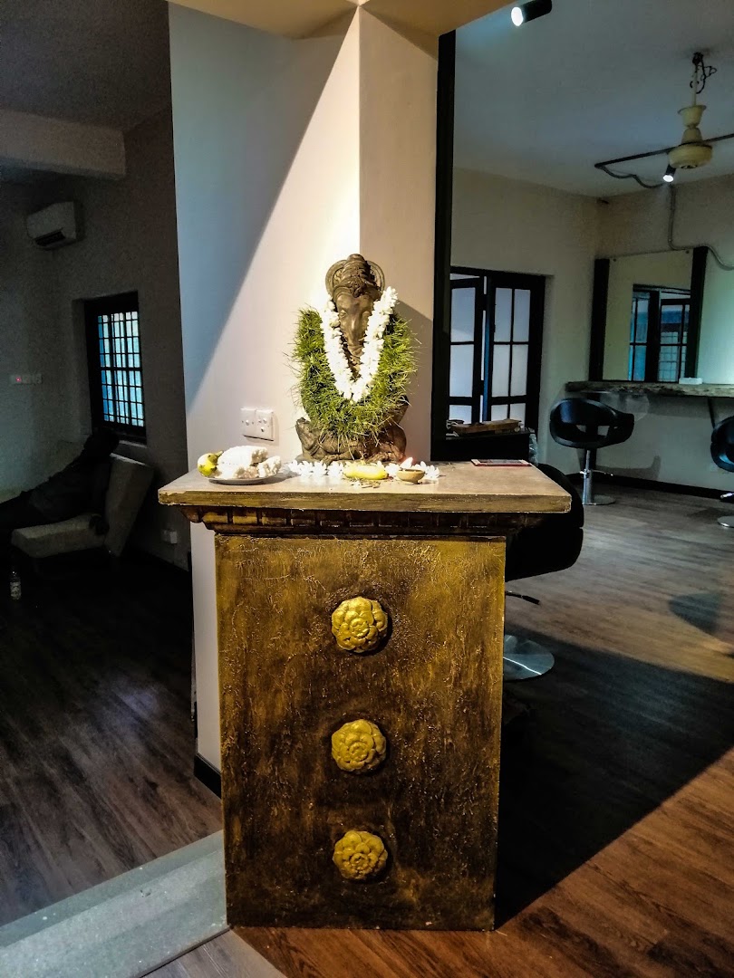 Salon interior with a garlanded display, timber floor, and styling chairs