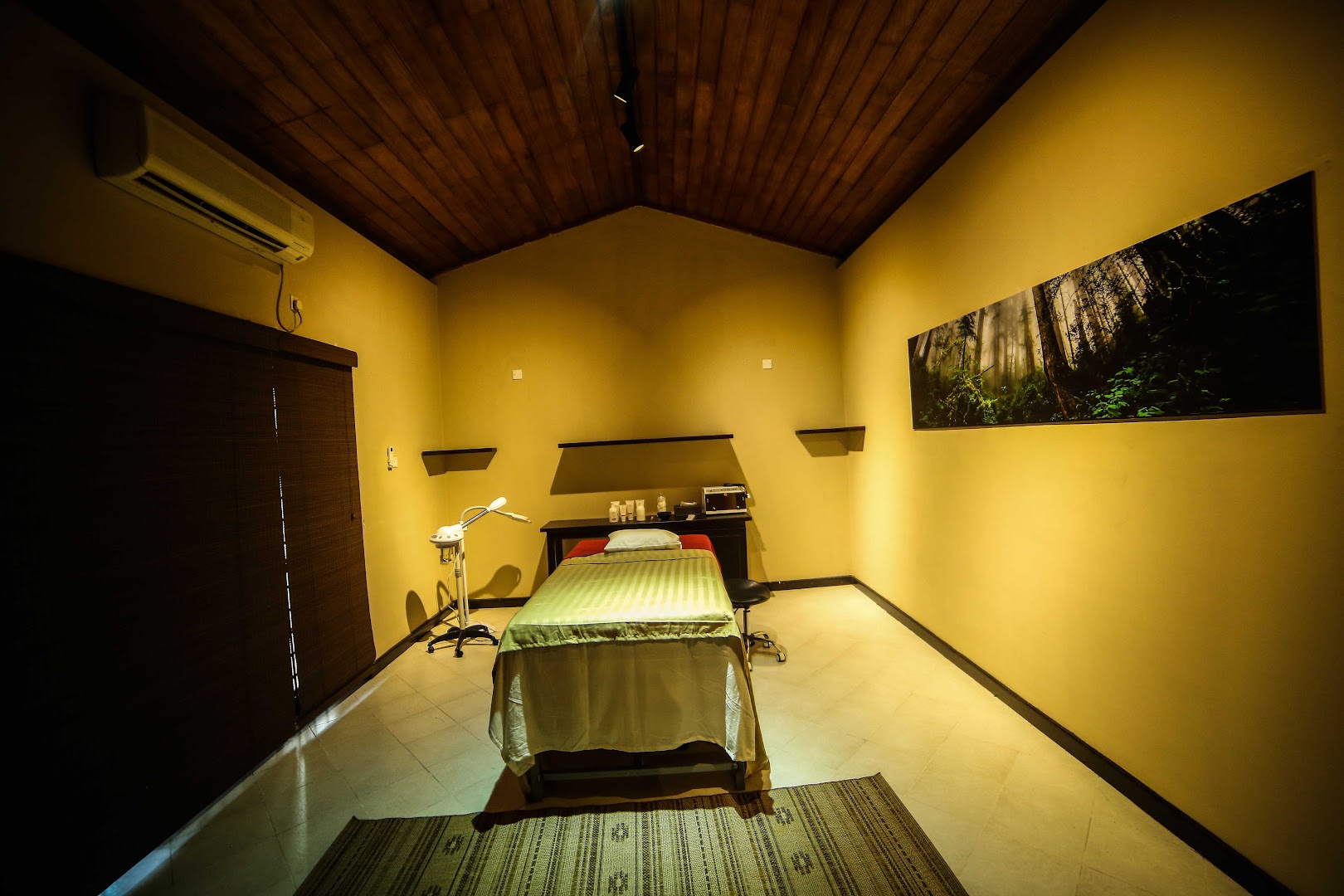 Warm treatment room with a timber ceiling and a treatment bed