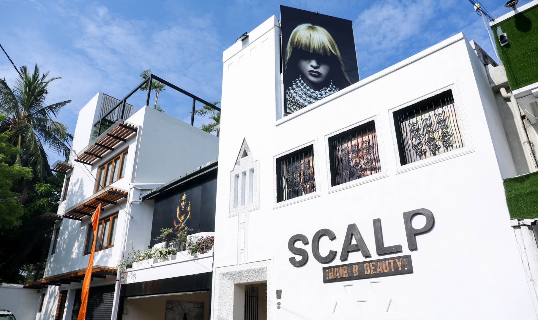 Bright white Scalp Hair and Beauty storefront with its large exterior sign