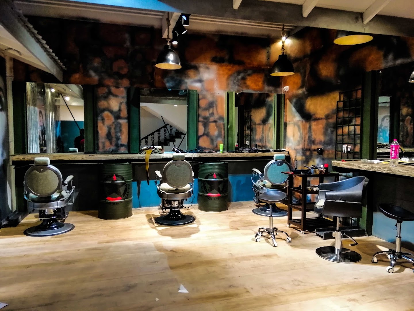Bright styling room with mirrors, salon chairs, and blue accents